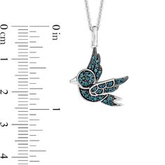 a bird with blue crystals on it's wings is shown next to a ruler