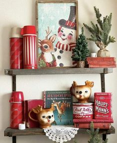 two shelves with christmas decorations and books on them