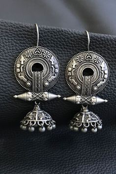 Our Rabari Earrings are handmade by artisans in Gujarat, India using brass with silver finish in an artistic tribal design from this region. Our fair trade earrings are are made with high quality materials and come in a range of beautiful designs, and showcase the fine metal craft traditions of India. Traditional Artistic Design Drop Earrings, Traditional Oxidized Hoop Earrings For Festive Occasions, Traditional Brass Earrings For Festivals, Traditional Festive Metal Earrings, Traditional Metal Earrings For Festive Occasions, Festive Handmade Metal Earrings, Bohemian Jhumkas With Intricate Design, Traditional Dangle Jewelry With Artistic Design, Sterling Silver Bohemian Jhumkas