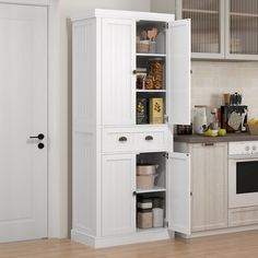 a kitchen with white cabinets and wooden floors