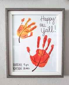 a handprint with the words happy fall y'all written on it is hanging in a frame