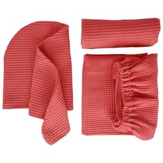 a set of red towels and napkins on a white background