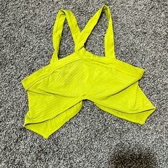 Cropped Halter Top Super Soft And Stretchy Spandex Like Material. Size M/L This Is In Great Condition Nwot. Summer Tops With Built-in Bra For Workout, Green Vacation Top With Built-in Bra, Yellow Stretch Top With Built-in Bra, Summer Triangle Top With Seamless Construction, Casual Solid Color Triangle Top, Summer Workout Tops With Built-in Bra, Summer Workout Tops With Seamless Design, Yellow Seamless Beach Tops, Urban Outfitters Sleeveless Crop Top With Built-in Bra