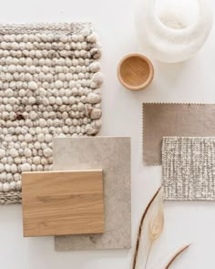 the materials needed to make a rug are laid out on a white surface, including wood and wool