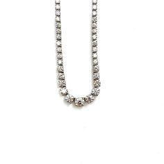 This stunning graduated diamond necklace features 111 diamonds weighing 17.89 ct set in platinum. The diamonds boast a color of F/G with a clarity of VS2/SI1. This must-have piece is a definite showstopper for any wardrobe. Vvs Clarity Diamond Necklace In Classic Style, Classic Crystal Tennis Necklace With Prong Setting, Classic Round Tennis Necklace With Rhinestones, Classic Round Rhinestone Tennis Necklace, Classic Crystal Tennis Necklace, Classic Crystal Tennis Necklace With Brilliant Cut, Classic Diamond Necklace With Rhinestones For Gift, Classic Rhinestone Tennis Necklace For Anniversary, Classic Diamond White Rhinestone Tennis Necklace