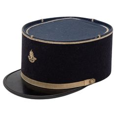 A rare French Military Academy Officer's hat or cap from the 1970s. These special and unique hats are part of the uniform of students studying to become officers in the French Military. This cap features a black leather brim on black felt with a blue top. There is a gold band around the brim and gold band at the top with a gold braid on the top and a gold emblem on the front. 6.25"w x 10"d x 4.25"h. Wear consistent with age and use. French Military, Black Tears, Military Academy, Military Hat, Unique Hats, Vintage Military, Arte Popular, Black Felt, Fantasy Inspiration