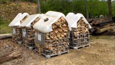 several stacks of firewood stacked on top of each other in front of some logs