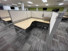 an office cubicle with two desks and one chair on the other side is empty