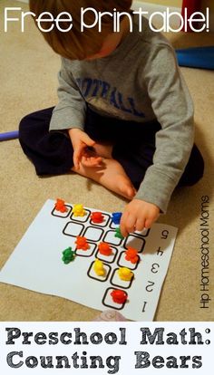 a young boy sitting on the floor playing with his counting bears activity book, free printable