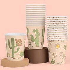 a stack of paper cups with cactus designs on them, sitting next to each other