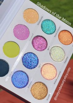 > The Shadows of the Moon Palette is our newest installment of Hybrid Shimmer shades. These beautiful duochrome Hybrids are infused with holographic shimmer to add that holo effect to each multidimensional shadow. The palette also includes soft buttery Shimmer Mattes, Regular Mattes, Holo Shimmer Shades, Duochromes and Hybrids.   Pro tip: We love using the shades with a hard bristles eyeshadow or eyeliner brush to easily pick up the pigments for Application 😍     + Vegan & Cruelty Free  + 12 un Purple Iridescent Eyeshadow, Eyeshadow Palette Purple, Rainbow Eyeshadow Palette, Shiny Purple Eyeshadow, Iridescent Eyeshadow Palette, Shimmer Eyeshadow Palette, Duochrome Eyeshadow, Unicorn Makeup, Magical Makeup