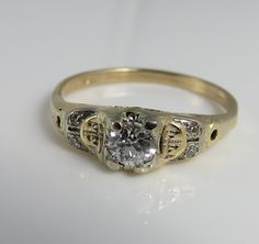 Estate 14k yellow gold diamond .45 center stone and 4 side diamnds ring. clean quality stones . vs 2. size 7.75. 2 grams. estate 30's. marked 14k. Vintage White Gold Diamond Ring Stamped 14k, Vintage White Gold Diamond Ring 14k, Vintage Yellow Gold Round Diamond Ring, Heirloom 14k Stamped Round Wedding Ring, Antique Yellow Gold Brilliant Cut Diamond Ring, Antique Brilliant Cut Diamond Ring In Yellow Gold, Antique Yellow Gold Diamond Ring, Antique Brilliant Cut Yellow Gold Diamond Ring, Antique Yellow Gold Diamond Ring With Round Cut