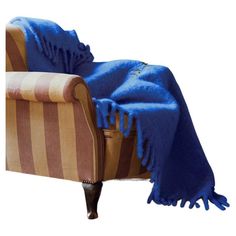 a chair with a blue blanket on top of it and a brown striped arm chair