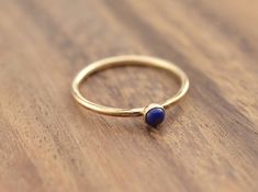 "Beautiful birthstone lapis lazuli stacking ring. Made in 14k gold filled and stones are 3mm. This ring is made to order in your size. If you don't see your size available please feel free to message me. Also available with garnet, carnelian, moonstone, turquoise, or simulated opal. Put your birthstone choice in \"Notes to Seller\" at checkout. Please message me for availability and pricing if interested in a stone not listed. All orders ship in a gift box. If you are ordering multiple items and Yellow Gold Lapis Lazuli Minimalist Jewelry, Minimalist Yellow Gold Lapis Lazuli Jewelry, Minimalist Round Lapis Lazuli Jewelry, September Birthstone Ring, September Birthstone Rings, Lapis Lazuli Ring, Gold Ring Stack, September Birthstone, Ring Gemstone