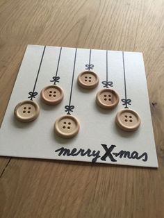 six wooden buttons on a card that says merry xmas