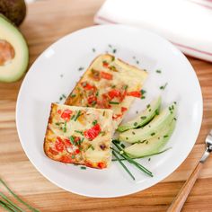 two pieces of food on a plate next to an avocado