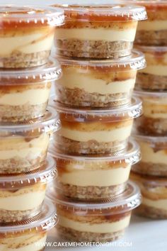 there are many desserts in plastic containers stacked on top of each other, ready to be eaten