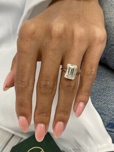 a close up of a person's hand with a ring on it