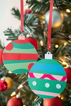 two ornaments hanging from a christmas tree with red and green ornaments on it's sides