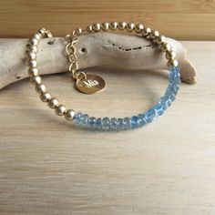 Blue Aquamarine Gemstone Bracelet, Blue and Gold Bracelet, Bridal Something Blue Bracelet, Personalized Gift for Bridesmaid, Santa Maria Aqua ❤Please note this listing includes ONE bracelet! ABOUT THIS BRACELET** **PLEASE SEE MEASUREMENTS BELOW** This remarkable bracelet is adorned with gorgeous Santa Maria Aquamarine gemstones that measure 4mm. These AA gems are in the beryl family, are semi-transparent with light and medium blue hues, and exhibit some internal characteristics. ❤I have added a Blue Hand Wrapped Bracelet, Adjustable Blue Crystal Bracelet With Gemstone, Adjustable Blue Crystal Gemstone Bracelet, Adjustable Blue Gemstone Crystal Bracelet, Blue Gemstone Beads Bangle, Blue Gemstone Beads Bangle Jewelry, Blue Gemstone Bead Bangle, Blue Faceted Beads Bangle Jewelry, Blue Bangle With Faceted Beads