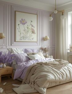 a white bed sitting next to a window in a bedroom under a painting on the wall