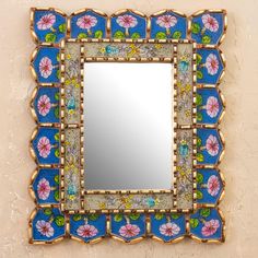 a decorative mirror mounted to the side of a wall