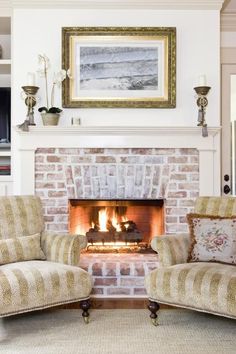 a living room with two chairs and a fire place