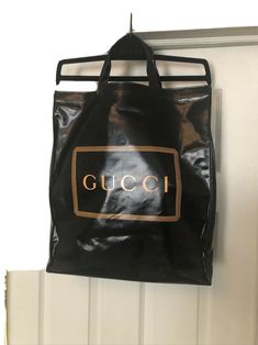 GUCCI Printed Logo / Black Coated Cotton Medium Tote Bag NWT 575140 Gucci’s Coated Canvas Logo Vertical Tote Black signature tropes – playful detailing and bold motifs– are evident in black PVC with logo print. The Tote Bag is crafted from a canvas blend fabrication in a coated weave, featuring a front logo print, two CIRCULAR top handles and an open top. The top opens to a spacious black fabric interior. Gucci Unisex Printed Black Tote Bag Style 575140 G0BA0 8288 Black Coated w/ Framed Gucci Lo Modern Gucci Shoulder Bag For Shopping, Black Gucci Bag With Logo, Gucci Business Bag With Logo, Black Gucci Shoulder Bag With Logo, Everyday Gucci Bag With Logo, Gucci Everyday Bag With Logo, Designer Logo Bags For Shopping, Designer Logo Rectangular Shopping Bag, Rectangular Designer Logo Bag