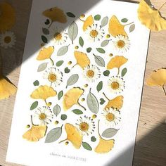 a card with yellow flowers and leaves on it next to some other cards that have been cut out