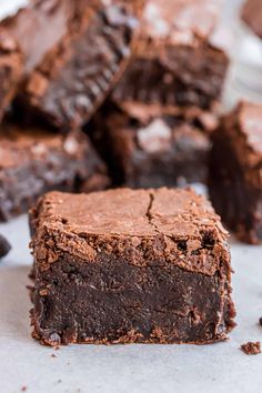 chocolate brownies cut into squares and stacked on top of each other with one bite taken out