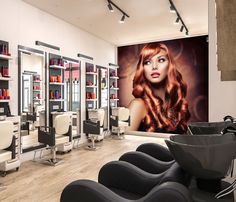 a hair salon with chairs and pictures on the wall