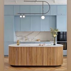 a kitchen with blue cabinets and an island