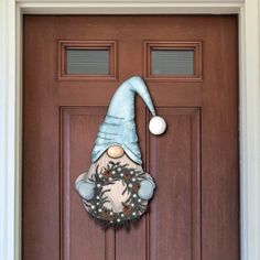 a door with a wreath and a gnome's hat on it