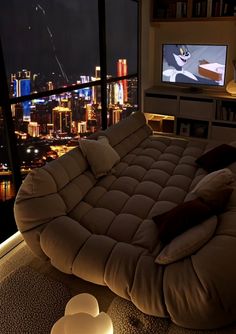 a living room filled with furniture and a large window