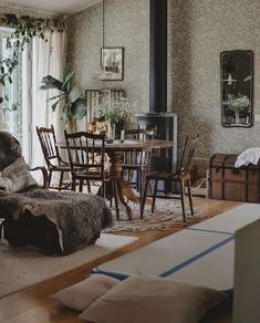 a living room filled with furniture and a fire place in the middle of a room