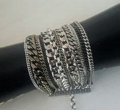 "♦ A Beautiful unique layer bracelet is full of chic and presence, is suitable for both man and woman The bracelet is made of rows of different chains and different shades of silver, a mix of black color, oxide silver, and gloss silver. SIZE Length:6.3\"(16cm) up to 8.3\" (21cm) width: 1.77\" (4.5) Material: brass plated silver ♦ This piece of jewelry is perfect as a gift for yourself, for a friend, Valentine's day or a birthday. If ♦ The jewel will be sent by registered mail (to some countries Silver Chunky Chain Bangle Bracelet, Silver Bracelets With Double Chain As A Gift, Silver Double Chain Bracelet As Gift, Silver Double Chain Bracelet For Gift, Silver Bracelets With Double Chain And Adjustable Fit, Adjustable Silver Double Chain Bracelet, Silver Double Chain Bracelet, Party Metal Bracelets With Double Chain, Modern Silver Double Chain Bracelet