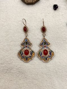 Cloisonne earrings made of high quality silver. Colored quality enamel is used.It was decorated with a carnelian stone as a precious stone. This Turkmen earrings is gold plated.this bohho style ethnic earrings is so elegant and delicate. This traditional silver earrings was designed and made by ourselves, entirely by hand. The product is an tribal earrings that is very clean and delicately made and ready to ship. PRODUCT İNFORMATİON : Material   : SİLVER Stone       : RED AGATE Length     : 5 CM Traditional Red Enamel Jewelry, Pierced Enamel Drop Earrings, Traditional Red Filigree Earrings, Bohemian Enamel Jewelry With Inlay, Bohemian Enamel Inlay Jewelry, Red Enamel Pierced Earrings, Ornate Red Sterling Silver Earrings, Red Pierced Enamel Earrings, Silver Enamel Drop Earrings