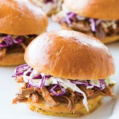 three pulled pork sandwiches on a white plate