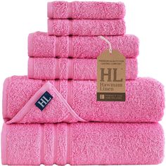 pink towels stacked on top of each other in front of a white background with a tag that says hl