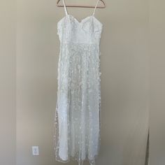 a white dress hanging on a hanger