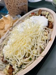 a tray filled with food and chips on top of a table