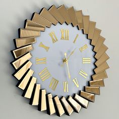 a large clock with gold roman numerals on it's face and hands