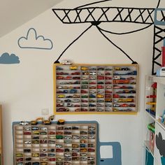 a child's bedroom with toy cars and toys on the wall next to it