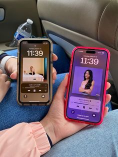 two people sitting in the back seat of a car, one holding a cell phone