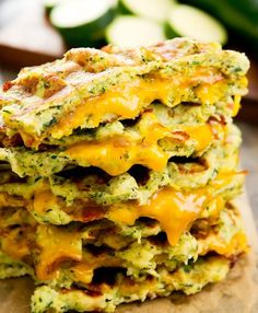 three cheesy zucchini fritters stacked on top of each other