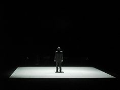 a man standing in the middle of a dark room