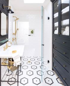 a black and white bathroom with skylight