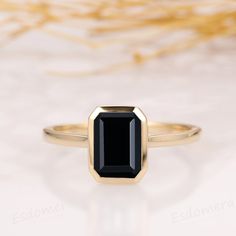 a black diamond ring sitting on top of a table