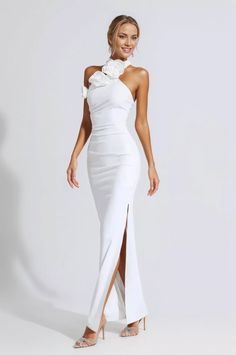 a woman wearing a white dress with a high slit