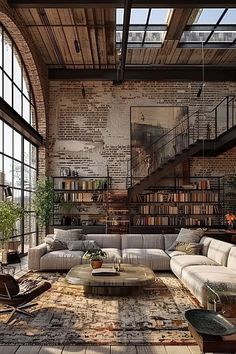 an industrial living room with exposed brick walls and large open floor to ceiling bookshelves